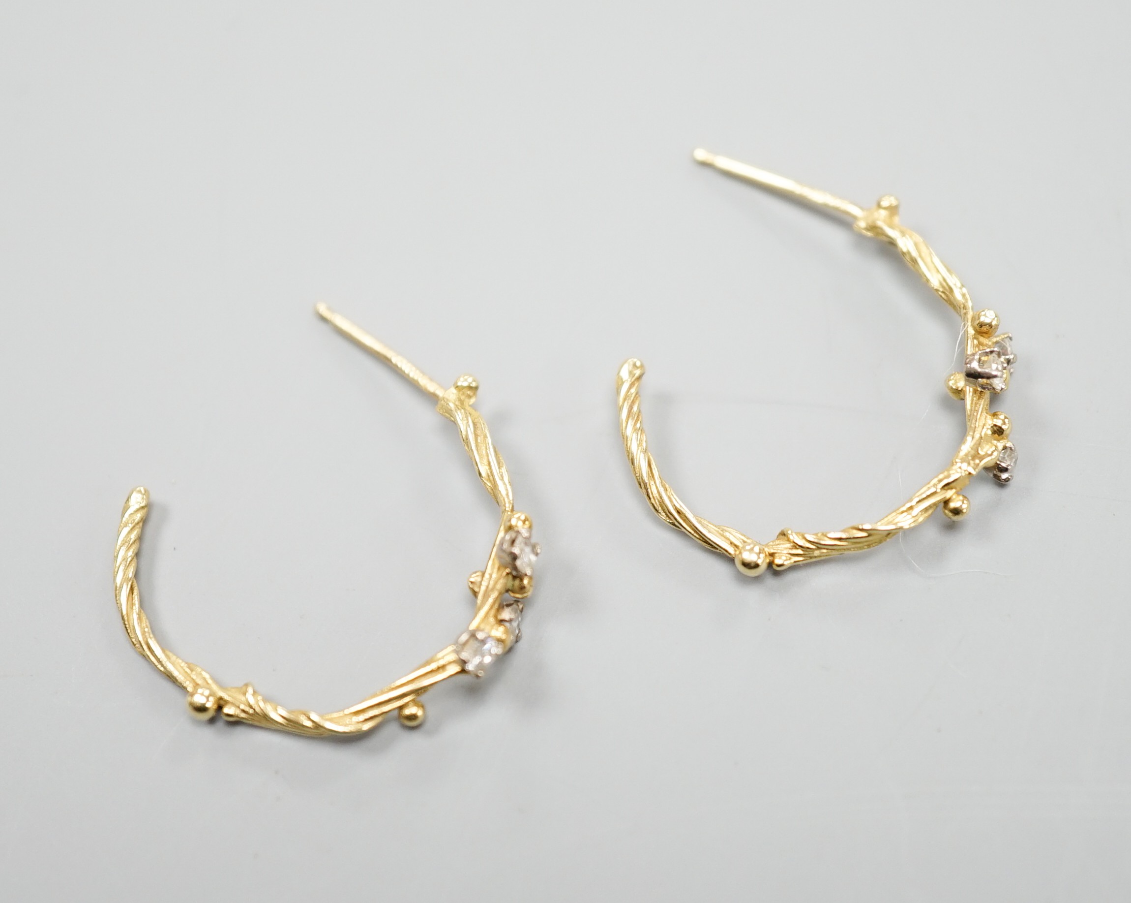 A pair of 18ct gold and three stone diamond set rustic hoop earrings, no butterflies, 25mm, gross weight 3.5 grams.